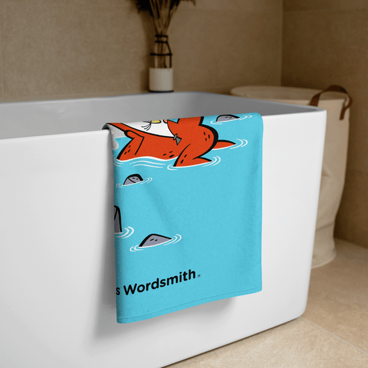 Beach towel with cartoon fox floating in water
