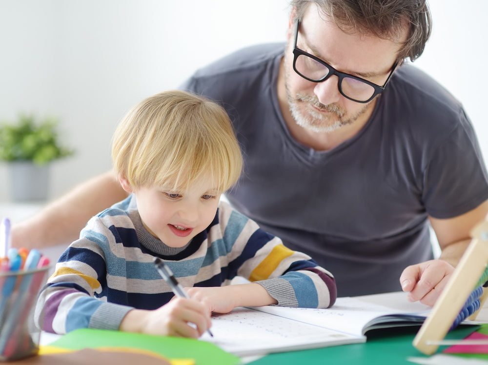 dad helping his son with the best workbooks for 1st grade
