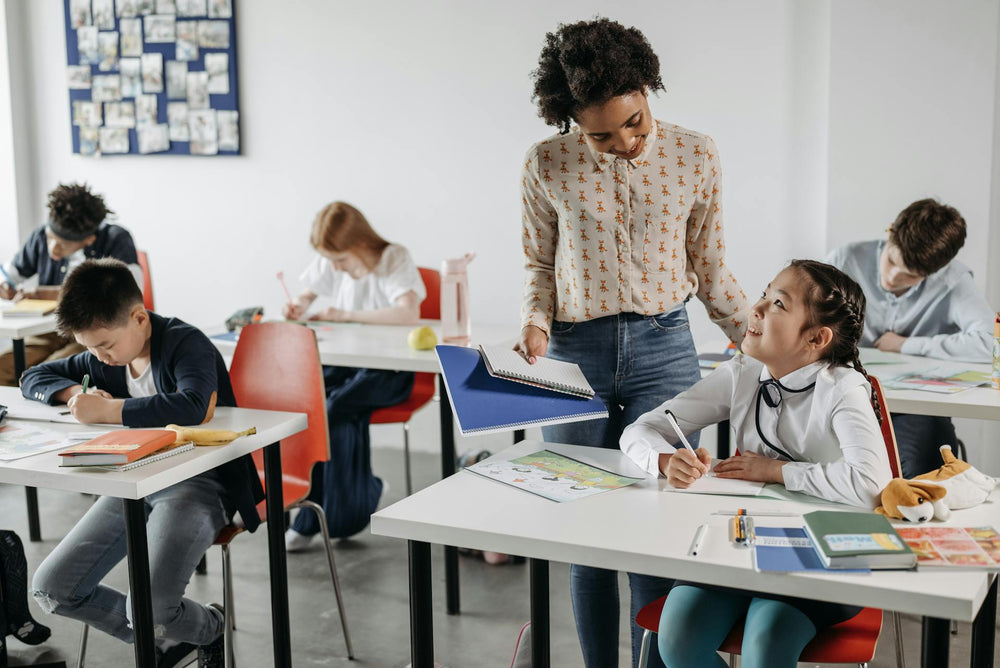 Confident teacher guiding students with the best teacher resource app for worksheets