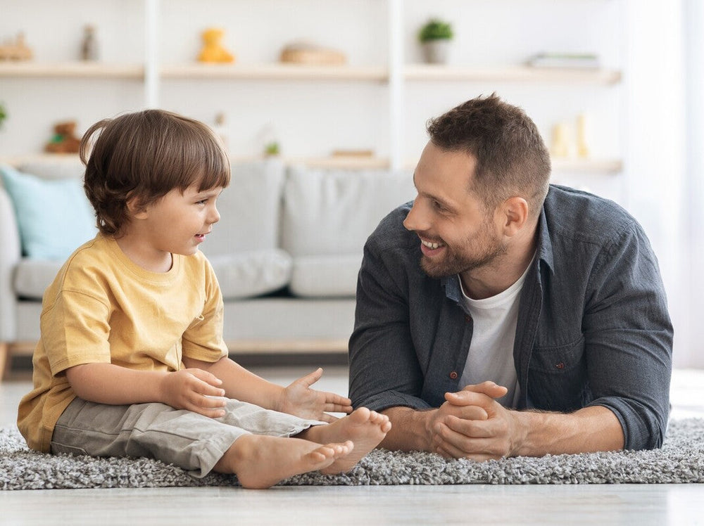 father and son talking in the living room, showing when kids start talking in sentences
