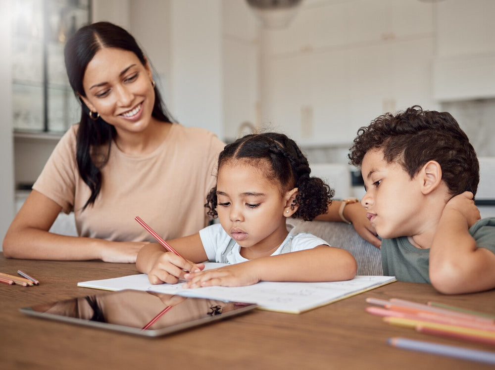 mom showing how to teach spelling to kids by helping her children with their spelling homework