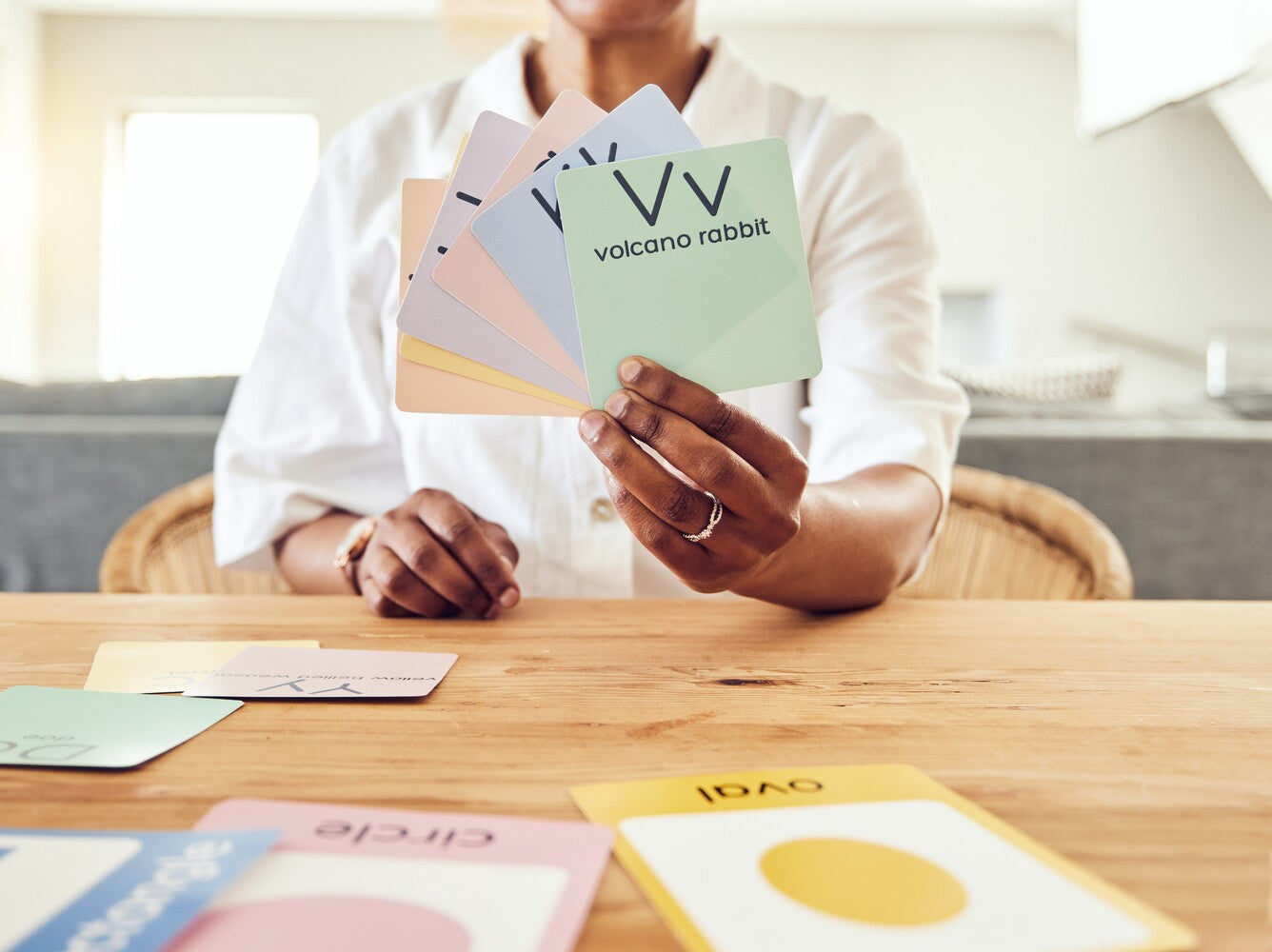 teacher holding up flash cards with words and letters for phonics and how to teach a child to read